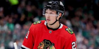 A close-up photograph of hockey player Jason Robertson wearing a red Chicago Blackhawks home jersey and sleeve number 21, looking off to the side, illustrating a hypothetical NHL trade scenario.
