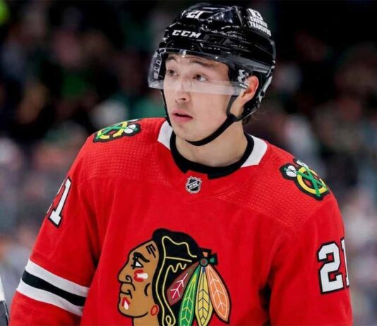 A close-up photograph of hockey player Jason Robertson wearing a red Chicago Blackhawks home jersey and sleeve number 21, looking off to the side, illustrating a hypothetical NHL trade scenario.