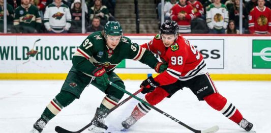 Will Bedard Upset the Wild? Blackhawks vs Wild TV Guide & Prediction Kirill Kaprizov and Connor Bedard battling for a loose puck during a Chicago Blackhawks vs. Minnesota Wild game.