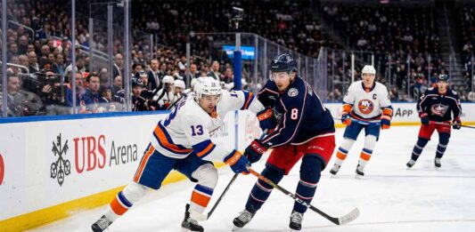 How to Watch Columbus Blue Jackets at New York Islanders on TV & Stream Mathew Barzal (#13) of the New York Islanders and Zach Werenski (#8) of the Columbus Blue Jackets competing for a puck during an NHL game at UBS Arena.