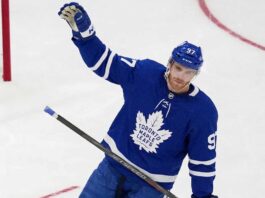 Connor McDavid Trade Rumors: Will He Leave the Edmonton Oilers? View of superstar Connor McDavid wearing a Toronto Maple Leafs away jersey with number 97, illustrating potential future NHL trade rumors and free agency speculation.