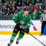 Dallas Stars winger Jason Robertson (number 21) in action, skating with focused intensity during a home game on American Airlines Center ice, highlighting his key role before a potential $12 million contract negotiation.