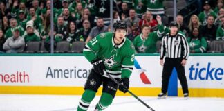 Dallas Stars winger Jason Robertson (number 21) in action, skating with focused intensity during a home game on American Airlines Center ice, highlighting his key role before a potential $12 million contract negotiation.