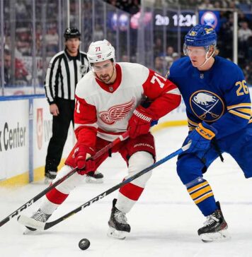 How to Watch Detroit Red Wings vs Buffalo Sabres on TV & Streaming (March 27, 2026) Dylan Larkin of the Detroit Red Wings battles Rasmus Dahlin of the Buffalo Sabres for the puck on the ice at KeyBank Center during an NHL Atlantic Division game.