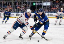 How to Watch the Edmonton Oilers at St. Louis Blues: TV Channels, Odds, & Predictions Edmonton Oilers captain Connor McDavid (#97) battling St. Louis Blues forward Robert Thomas (#18) for puck possession during an NHL regular season game at Enterprise Center in St. Louis.