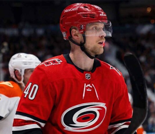 Elias Pettersson Trade Rumors: Vancouver Canucks to Carolina Hurricanes Elias Pettersson of the Vancouver Canucks, wearing the blue orca jersey, looks focused on the ice during an NHL game, fueling trade rumors linking him to the Carolina Hurricanes.