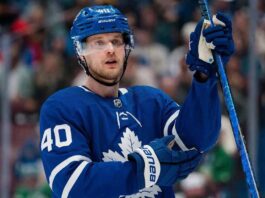 A jersey swap photo illustration of Elias Pettersson wearing a Toronto Maple Leafs home uniform, visually representing the rumored blockbuster trade from the Vancouver Canucks.
