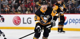Erik Karlsson of the Pittsburgh Penguins skating on the ice during an NHL game.