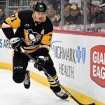 Pittsburgh Penguins center Evgeni Malkin (71) skating with the puck during an NHL game, fueling speculation about his future and a potential offseason trade.