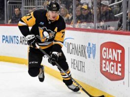 Pittsburgh Penguins center Evgeni Malkin (71) skating with the puck during an NHL game, fueling speculation about his future and a potential offseason trade.