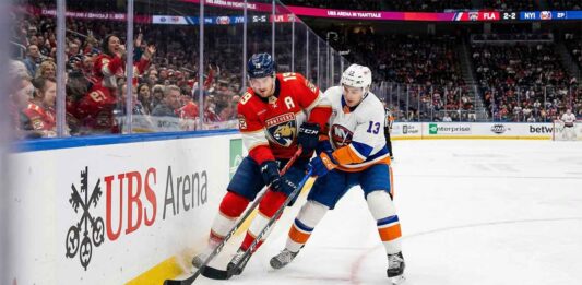 How to Watch the Florida Panthers vs. New York Islanders on TV & Streaming Today Florida Panthers forward Matthew Tkachuk (#19) and New York Islanders center Mat Barzal (#13) battling intensely for a loose puck against the boards during an NHL game at UBS Arena on March 1, 2026.