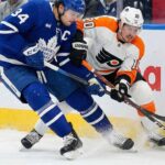 Will the Maple Leafs Survive the Flyers? TV Options & Odds Auston Matthews of the Toronto Maple Leafs and Travis Konecny of the Philadelphia Flyers battle for the puck along the boards during an NHL game.