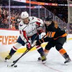 Alex Ovechkin of the Washington Capitals battles Travis Konecny of the Philadelphia Flyers for the puck during a Metropolitan Division NHL game.