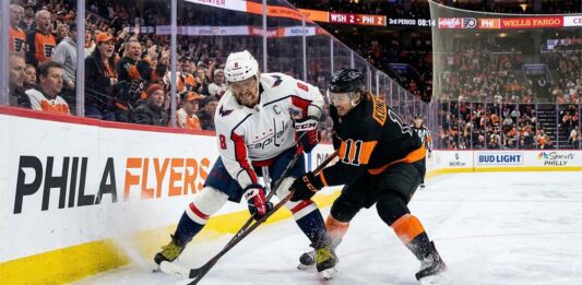 Alex Ovechkin of the Washington Capitals battles Travis Konecny of the Philadelphia Flyers for the puck during a Metropolitan Division NHL game.