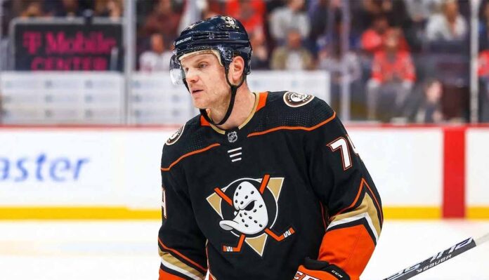 NHL defenseman John Carlson on the ice during a game, subject of Anaheim Ducks contract extension rumors and NHL trade analysis.
