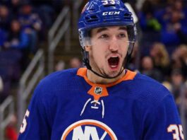 A concept image showing St. Louis Blues forward Jordan Kyrou celebrating while wearing a New York Islanders home jersey, reflecting major NHL trade deadline rumors linking the goal-scorer to Long Island.