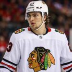 A detailed jersey swap visualization showing Toronto Maple Leafs forward Matthew Knies wearing a white Chicago Blackhawks uniform with number 23, illustrating NHL trade rumors between the two teams.