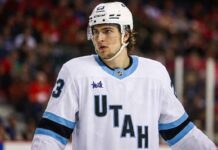 Matthew Knies wearing a conceptual white Utah Mammoth away jersey with a mammoth logo on the chest, illustrating NHL trade rumors involving the Toronto Maple Leafs and the Utah franchise.