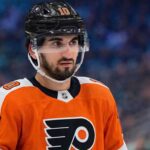 Matty Beniers to the Philadelphia Flyers? Analyzing the Blockbuster Kraken Trade Rumor A photo visualization of Seattle Kraken center Matty Beniers wearing a Philadelphia Flyers orange home jersey, representing ongoing NHL trade rumors and speculative scenarios linking the two teams.