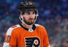 A photo visualization of Seattle Kraken center Matty Beniers wearing a Philadelphia Flyers orange home jersey, representing ongoing NHL trade rumors and speculative scenarios linking the two teams.
