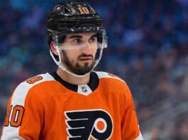 Matty Beniers to the Philadelphia Flyers? Analyzing the Blockbuster Kraken Trade Rumor A photo visualization of Seattle Kraken center Matty Beniers wearing a Philadelphia Flyers orange home jersey, representing ongoing NHL trade rumors and speculative scenarios linking the two teams.