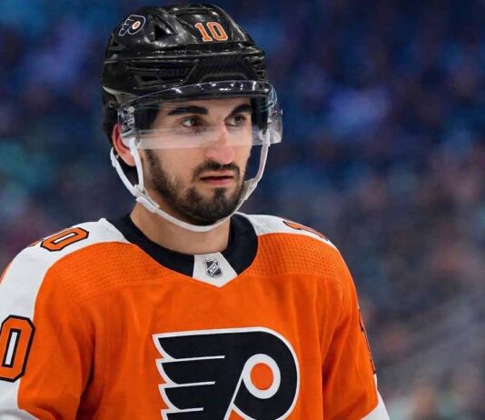 Matty Beniers to the Philadelphia Flyers? Analyzing the Blockbuster Kraken Trade Rumor A photo visualization of Seattle Kraken center Matty Beniers wearing a Philadelphia Flyers orange home jersey, representing ongoing NHL trade rumors and speculative scenarios linking the two teams.