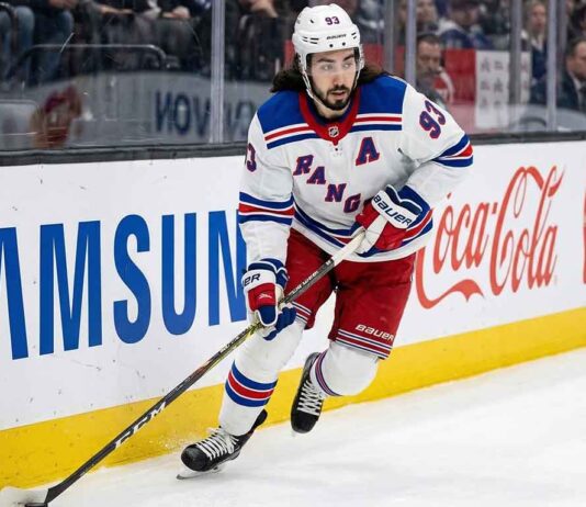 Mika Zibanejad Trade Rumors | New York Rangers Offseason Outlook New York Rangers forward Mika Zibanejad (93) skating with the puck along the boards during an NHL game.