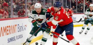 Kirill Kaprizov of the Minnesota Wild battles Matthew Tkachuk of the Florida Panthers for puck possession along the boards during an NHL game, previewing the March 26, 2026 matchup.