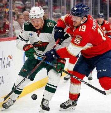 What Channel is the Wild vs. Panthers Game On? (March 26, 2026) Kirill Kaprizov of the Minnesota Wild battles Matthew Tkachuk of the Florida Panthers for puck possession along the boards during an NHL game, previewing the March 26, 2026 matchup.