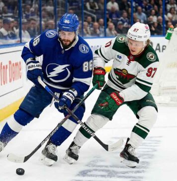 What Channel is the Minnesota Wild vs Tampa Bay Lightning Game On Tonight? Nikita Kucherov of the Tampa Bay Lightning battles for the puck against Kirill Kaprizov of the Minnesota Wild during their 2025-26 NHL regular season matchup on Tuesday, March 24, 2026.