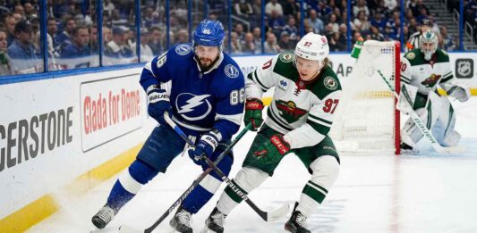 What Channel is the Minnesota Wild vs Tampa Bay Lightning Game On Tonight? Nikita Kucherov of the Tampa Bay Lightning battles for the puck against Kirill Kaprizov of the Minnesota Wild during their 2025-26 NHL regular season matchup on Tuesday, March 24, 2026.