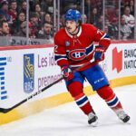 Montreal Canadiens defenseman Arber Xhekaj (#72) skating hard along the boards during an NHL game, amidst intense trade rumors surrounding his future with the team.