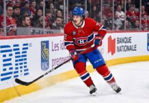 Montreal Canadiens defenseman Arber Xhekaj (#72) skating hard along the boards during an NHL game, amidst intense trade rumors surrounding his future with the team.