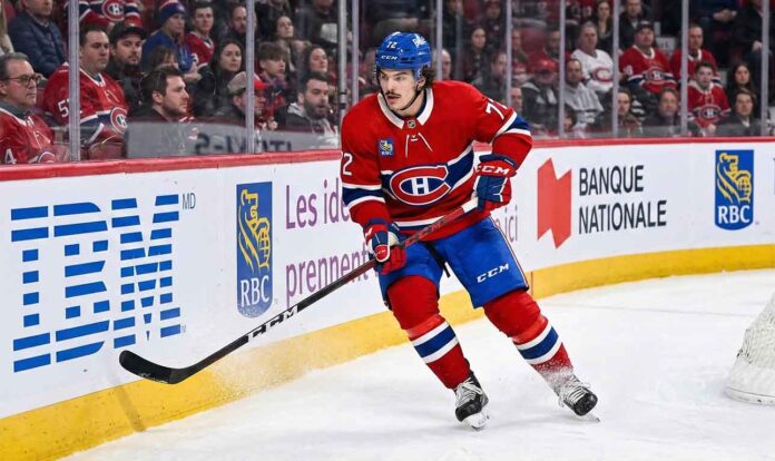 Montreal Canadiens defenseman Arber Xhekaj (#72) skating hard along the boards during an NHL game, amidst intense trade rumors surrounding his future with the team.