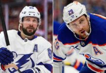 Latest NHL News & Scores Recap: March 18, 2026 Updates A side-by-side split portrait image featuring Nikita Kucherov #86 of the Tampa Bay Lightning on the left, and Leon Draisaitl #29 of the Edmonton Oilers on the right. Both players are in white away jerseys with the "A" patch during a game. This photo represents the top NHL news makers of March 18, 2026.