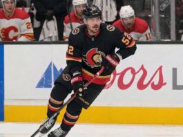 Ottawa Senators #52 MacKenzie Weegar skating with the puck on ice.