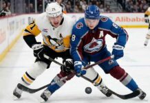 Cale Makar (8) of the Colorado Avalanche battles Evgeni Malkin (71) of the Pittsburgh Penguins for the puck during a high-stakes NHL game on March 16, 2026.