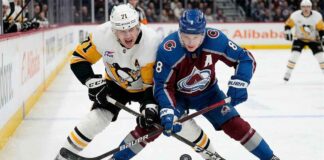 Cale Makar (8) of the Colorado Avalanche battles Evgeni Malkin (71) of the Pittsburgh Penguins for the puck during a high-stakes NHL game on March 16, 2026.