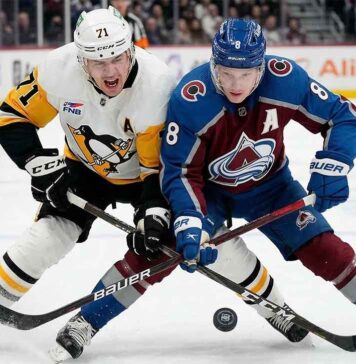 Cale Makar (8) of the Colorado Avalanche battles Evgeni Malkin (71) of the Pittsburgh Penguins for the puck during a high-stakes NHL game on March 16, 2026.