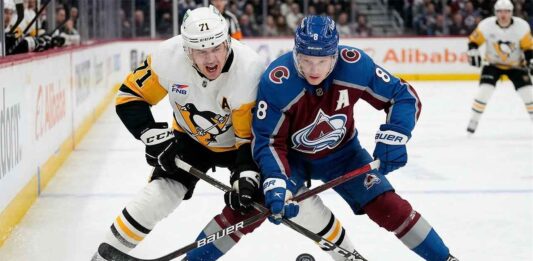 Cale Makar (8) of the Colorado Avalanche battles Evgeni Malkin (71) of the Pittsburgh Penguins for the puck during a high-stakes NHL game on March 16, 2026.