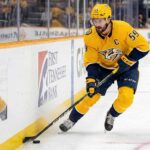 Nashville Predators captain Roman Josi controls the puck, pictured amidst swirling NHL trade rumors and speculation about a potential blockbuster move and a deep team rebuild.