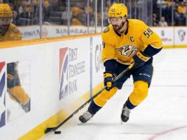 Nashville Predators captain Roman Josi controls the puck, pictured amidst swirling NHL trade rumors and speculation about a potential blockbuster move and a deep team rebuild.