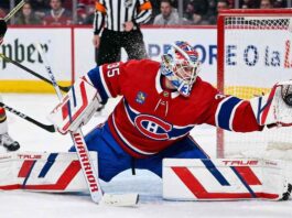 Montreal Canadiens goaltender Samuel Montembeault #35 makes a dramatic diving glove save during an NHL game amidst offseason NHL trade rumors.