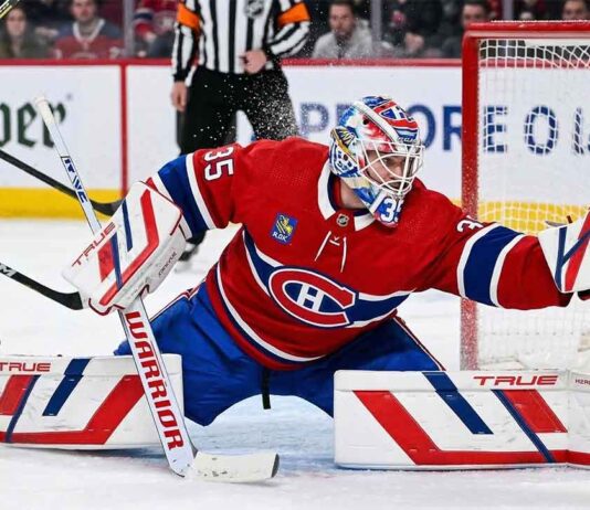 Montreal Canadiens goaltender Samuel Montembeault #35 makes a dramatic diving glove save during an NHL game amidst offseason NHL trade rumors.