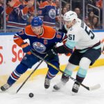 How to Watch Seattle Kraken at Edmonton Oilers on TV (March 31, 2026) Edmonton Oilers captain Connor McDavid (#97) battles for the puck with Seattle Kraken forward Shane Wright (#51).