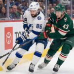 Will the Lightning Bounce Back? How to Watch Tampa vs Wild Tampa Bay Lightning forward Nikita Kucherov (86) and Minnesota Wild defenseman Quinn Hughes (43) battle for the puck along the boards during an NHL game.