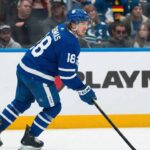 Why the Toronto Maple Leafs Kicking Tires on Robert Thomas Changes Everything A concept image visualized based on NHL trade rumors, showing current St. Louis Blues center Robert Thomas skating on the ice wearing a blue Toronto Maple Leafs home jersey with the number 18 and holding a hockey stick.