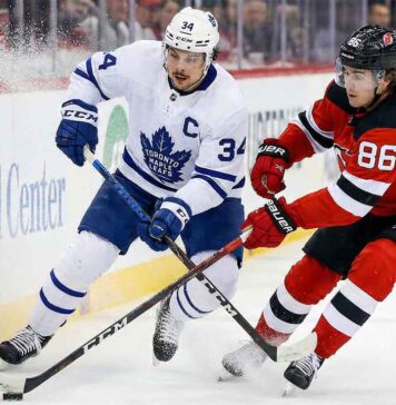 Will the Leafs Bounce Back? Toronto Maple Leafs vs New Jersey Devils TV & Odds Auston Matthews (Toronto Maple Leafs captain) and Jack Hughes (New Jersey Devils) battle intensely for puck possession along the boards at Prudential Center during a game leading up to the 2026 NHL trade deadline.