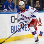 New York Rangers forward Vincent Trocheck (16) handles the puck during an NHL game, seen here amidst offseason NHL trade rumors.