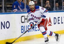New York Rangers forward Vincent Trocheck (16) handles the puck during an NHL game, seen here amidst offseason NHL trade rumors.